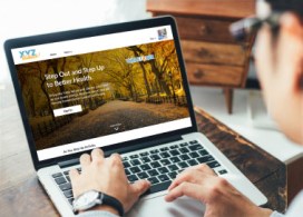 Man looking at the Elevate website on his laptop