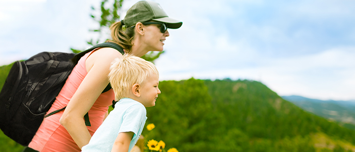 mother and young boy look at mountains