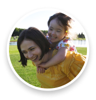 Mother giving her child a piggy back ride.