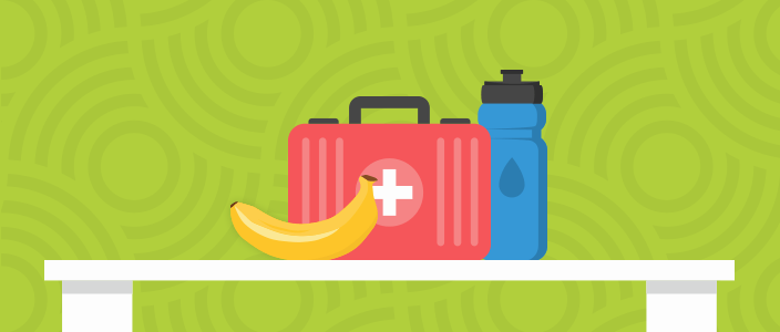 First aid kit, banana, and water bottle on a table