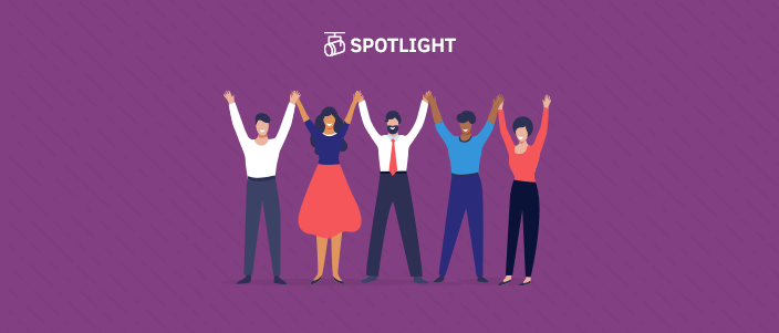 diverse group of people standing next to each other with their hands raised showing connection