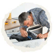 Man using a screwdriver to fix a washing machine.